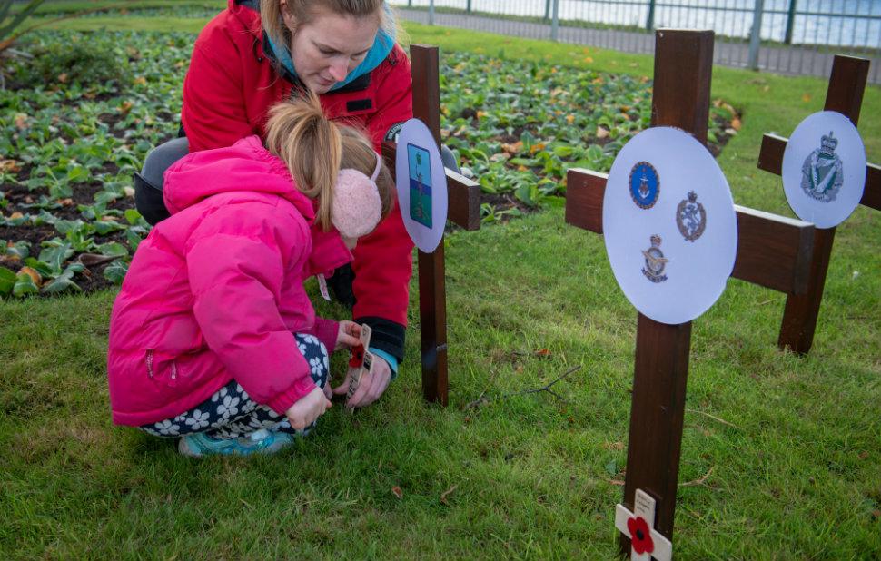 Woman and child at memorial poppy