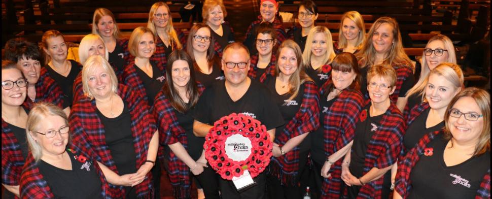 Ladies in tartan with shield of poppies